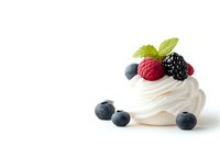 Delicate meringue nest topped with fresh berries and mint leaf on white background, soft whipped cream swirl garnished with raspberry, blackberry and blueberries.
