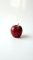Fresh red apple with glossy skin isolated on white background for healthy eating and nutrition concepts.