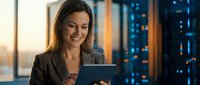 Professional businesswoman using digital tablet in modern office with city lights background at evening for corporate technology solutions.