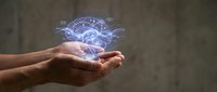 Hands holding glowing digital brain hologram with neural network connections representing artificial intelligence, machine learning and cognitive technology concepts.