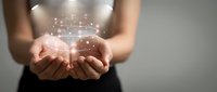 Female hands holding glowing digital network sphere with connected particles and light effects, representing data technology, innovation, and global connectivity for business concepts.