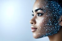 Young mixed race woman profile with glowing blue digital particles effect overlaying her hair, representing artificial intelligence and technology integration.