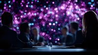 Silhouettes of business people at conference table with purple and blue bokeh lights in background creating magical atmosphere during presentation.