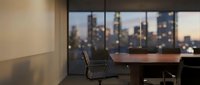 Executive office workspace with modern chair and wooden desk overlooking illuminated city skyline at dusk, suitable for corporate, business, and professional design projects.