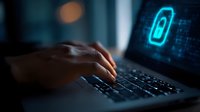 Dark close-up of hands typing on laptop keyboard with glowing blue battery icon and digital elements on screen, representing power management and technology.