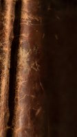 Aged brown leather texture with natural grain patterns and worn surface details for luxury craftsmanship and vintage material backgrounds.