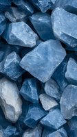 Blue rough stone chunks scattered together creating natural mineral texture background for construction and landscaping projects.