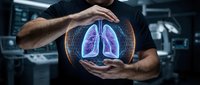 Caucasian male healthcare professional holding glowing digital lungs hologram in modern medical facility, representing respiratory health, pulmonology, and advanced diagnostic technology.