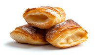 Freshly baked croissants with flaky golden crust and creamy custard filling stacked together on white background, perfect for bakery menu promotion.
