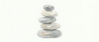 Stacked smooth stones balanced in zen tower formation on white background, isolated for wellness and meditation design projects.