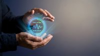 Businessman hands holding glowing holographic heart rate monitor display with vital signs data, healthcare technology and medical analytics concept.