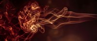 Abstract fiery swirls and flowing smoke patterns in warm orange and red tones creating dynamic energy movement on dark background for creative designs.