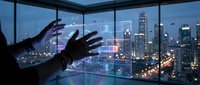 Businessman touching virtual interface screen with city skyline view through office windows at night showing digital technology and innovation.