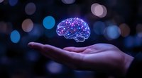 Glowing digital brain with neural network connections floating above open palm against dark background with bokeh lights, representing artificial intelligence.