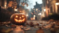 Glowing jack-o-lantern on autumn street with fallen leaves at dusk, creating spooky Halloween atmosphere against blurred city lights.