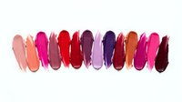 Colorful lipstick swatches in vibrant shades from pink to burgundy arranged in row on white background for cosmetic and beauty product design.