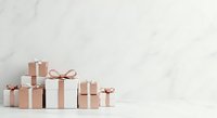 Isolated gift boxes with rose gold ribbons arranged on white marble background, ready for holiday, birthday, and celebration design projects.