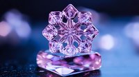 Delicate pink crystal snowflake macro photography with soft bokeh background, placed on reflective surface creating magical winter atmosphere and light refraction.