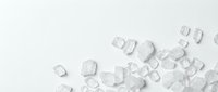 Scattered clear ice cubes on white surface, isolated and ready for beverage, food styling, and design projects.