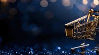 Miniature golden shopping cart on dark blue background with bokeh lights, symbolizing online retail and e-commerce business concept.