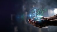 Hands holding glowing holographic dollar sign symbol with digital effects and light rays on dark background for financial technology concepts.