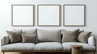 Modern minimalist living room interior with light gray sofa, brown throw pillows and three empty square frames on wall, mockup for artwork display.