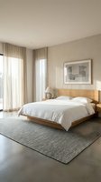 Serene bedroom interior with wooden bed frame, white linens, neutral curtains, and gray area rug. Minimalist decor for home design and hospitality projects.