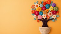 Colorful felt flower tree in striped ceramic pot against orange background, decorative handmade craft artwork for home decor and creative inspiration.