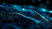 Glowing blue particles forming dynamic wave pattern against dark background, with bokeh light effects creating futuristic digital landscape for technology concepts.