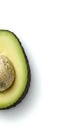 Fresh avocado half with pit isolated on white background for healthy cooking and nutrition concepts.