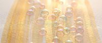 Golden yellow citrus slice with sparkling water droplets creating refreshing summer beverage concept for healthy lifestyle and nutrition content.