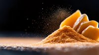 Fresh orange cantaloupe melon slices with brown sugar sprinkled in dramatic lighting against dark background, food photography with selective focus.