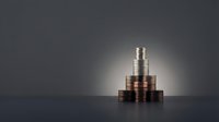 Stack of coins arranged in pyramid formation with dramatic lighting on dark background representing financial growth and investment success.