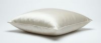 Luxurious silk satin pillow in ivory cream color isolated on white background, showcasing smooth glossy texture for bedding and home decor concepts.