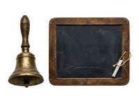 Vintage brass hand bell with wooden handle and weathered chalkboard slate with chalk, isolated on white background for educational, classroom, or nostalgic design projects.