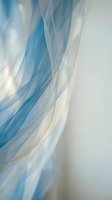 Flowing blue and white sheer fabric with soft waves and gentle curves, creating an elegant abstract background suitable for design projects and creative layouts.