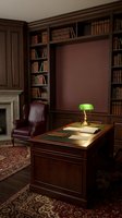 Elegant mahogany home office with built-in bookshelves, executive desk, green banker lamp, leather chair and fireplace for professional workspace design.