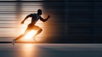 Dynamic silhouette of athletic runner in motion with dramatic lighting and speed lines creating sense of movement and energy for sports concepts.