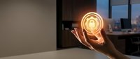 Hand holding glowing digital security lock icon in modern office environment representing cybersecurity and data protection technology solutions.
