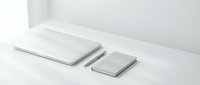 Minimalist white laptop and smartphone mockup on clean desk surface for modern workspace design and technology presentations.