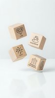 Wooden dice blocks with motivational symbols and words including love, equilibrium, unity, progress and growth for mindfulness and personal development.
