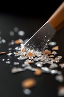 Sharp pencil breaking through glass on dark background with scattered shards and dramatic lighting creating reflective highlights and dynamic motion effect.