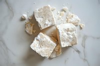 Fresh white tofu cubes on marble surface for healthy cooking and vegetarian cuisine preparation.