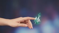 Hand pointing at glowing green upward arrow symbol representing growth, success and progress in business analytics and financial performance metrics.