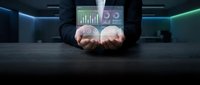 Businessman holding digital analytics dashboard with glowing charts and graphs for data visualization, business intelligence, financial reporting, and corporate performance monitoring.