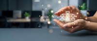 Digital house hologram glowing in hands against blurred office background, representing smart home technology, real estate investment, property management, and future housing solutions.