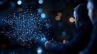 Businessman working late with glowing digital particle visualization floating above mobile device, dark office setting with bokeh lights in background.