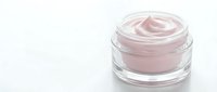 Pink cosmetic cream in glass jar isolated on white background, ready for skincare product packaging and beauty design use.