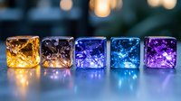 Glowing glass cubes with fairy lights inside arranged in row from yellow to purple creating magical bokeh effect on dark background, decorative lighting concept.