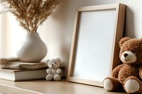 Mockup with blank wooden frame, brown teddy bears, white ceramic vase with dried pampas grass and books on wooden shelf in warm sepia tones.